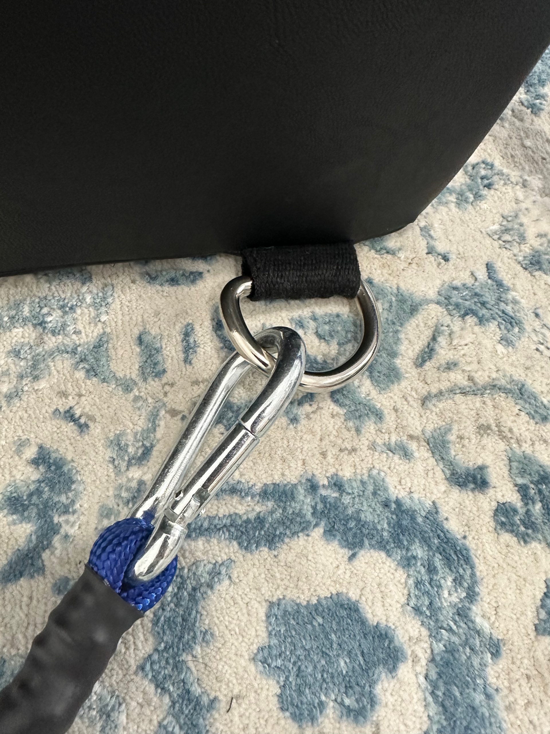 Close-up of the K-Fit wedge's carabiner clips connecting the resistance cords to fabric handles