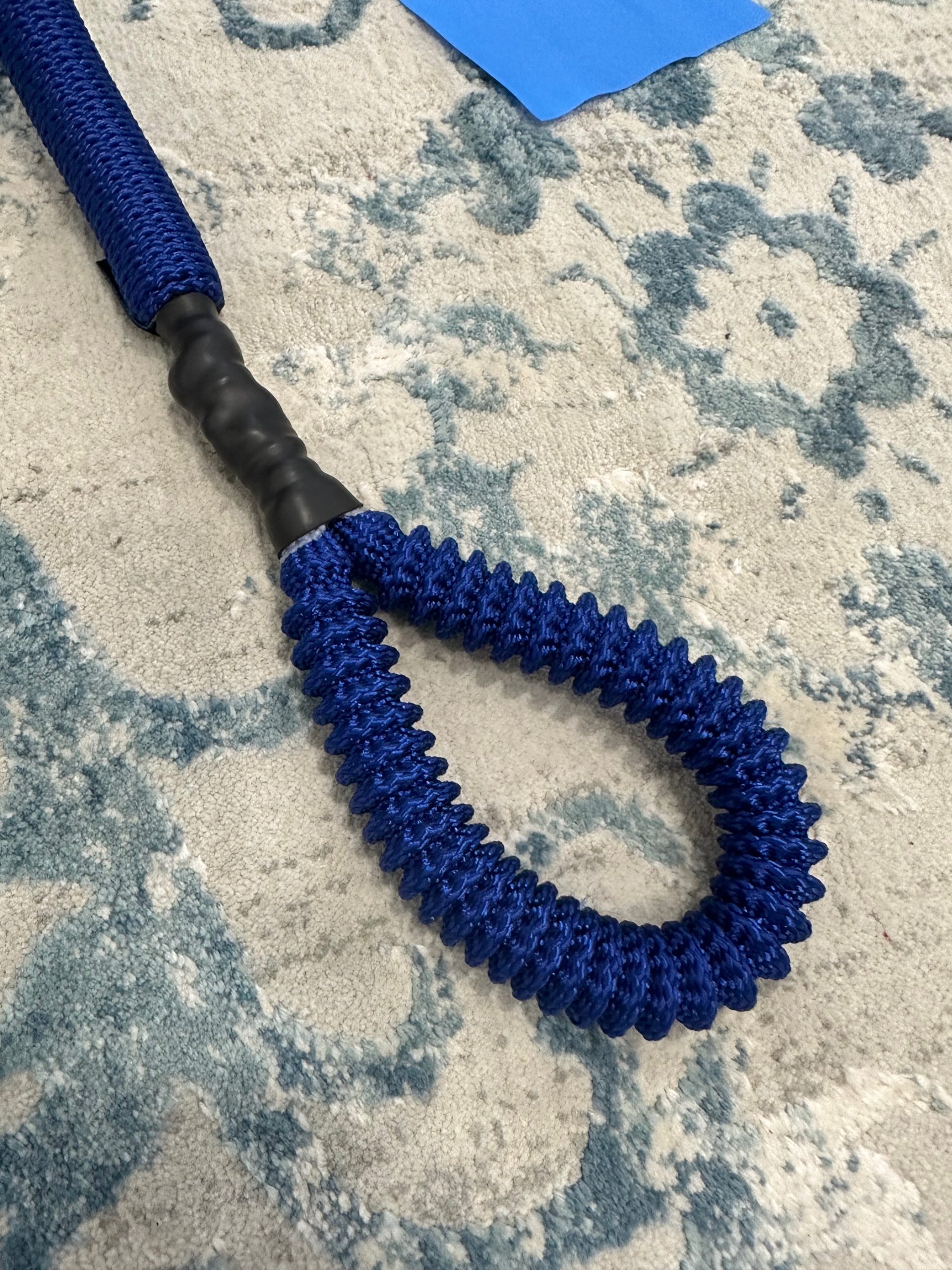 Close-up of a single blue resistance cord handle from the K-Fit wedge