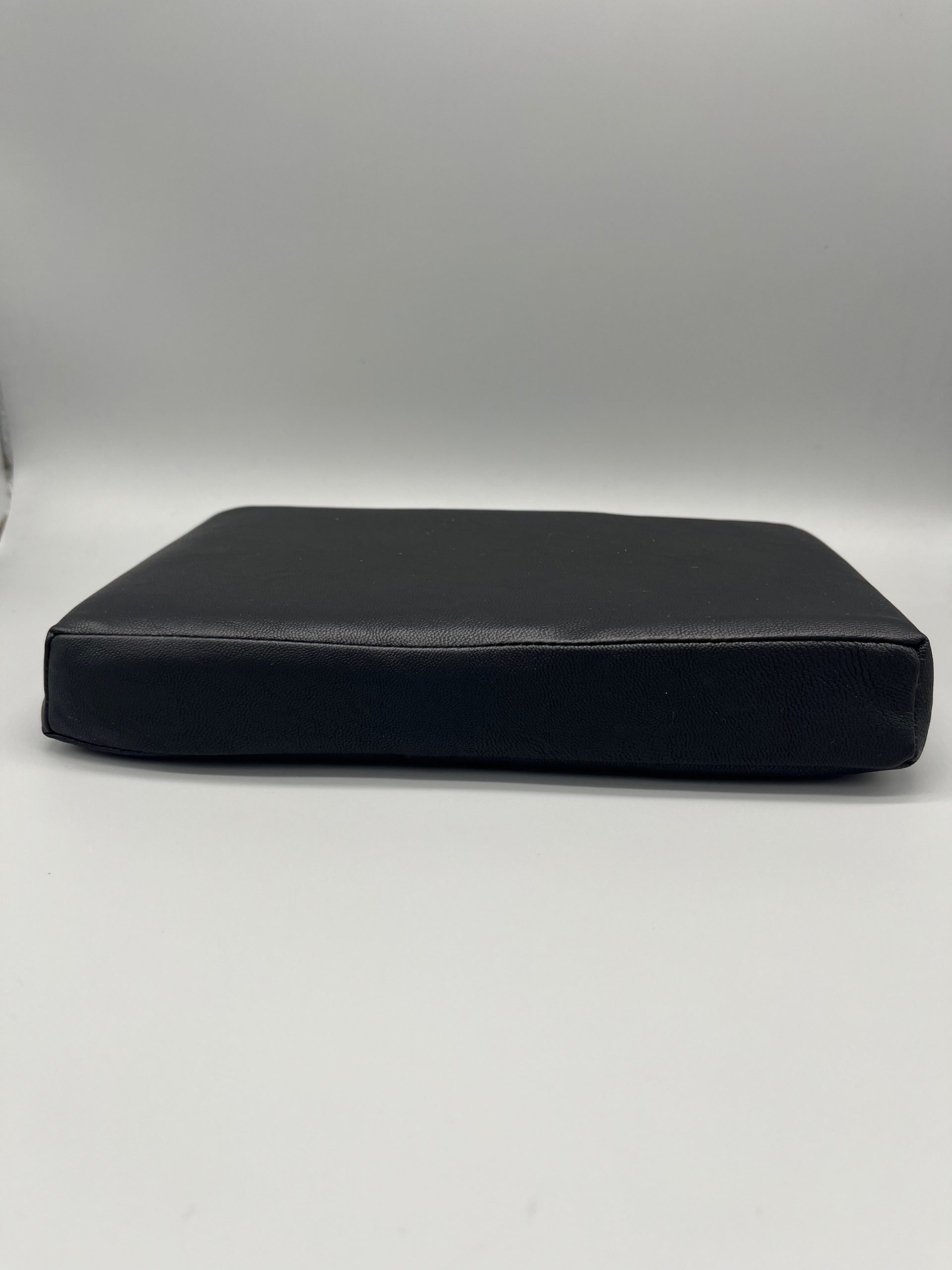 Black vinyl-covered Scoli-Flat wedge shown from the side, a low-profile Scolio-Pilates wedge