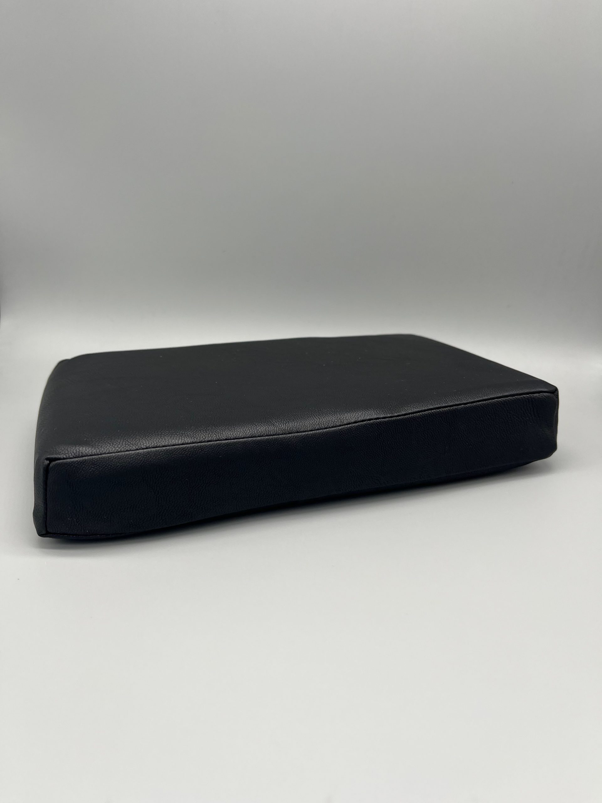 Black vinyl-covered Scoli-Flat wedge shown from the side, a low-profile Scolio-Pilates wedge