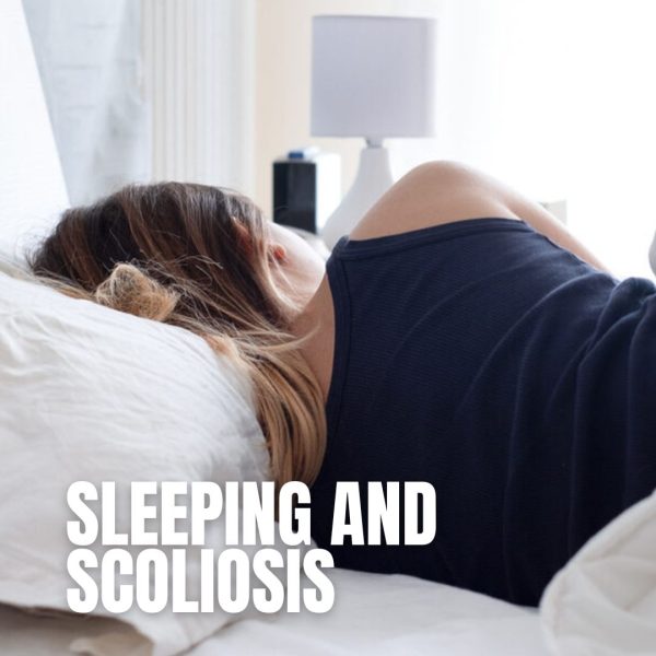 Woman lying on her side in bed, curled up under white bedding, resting peacefully with overlay text "sleeping and scoliosis"