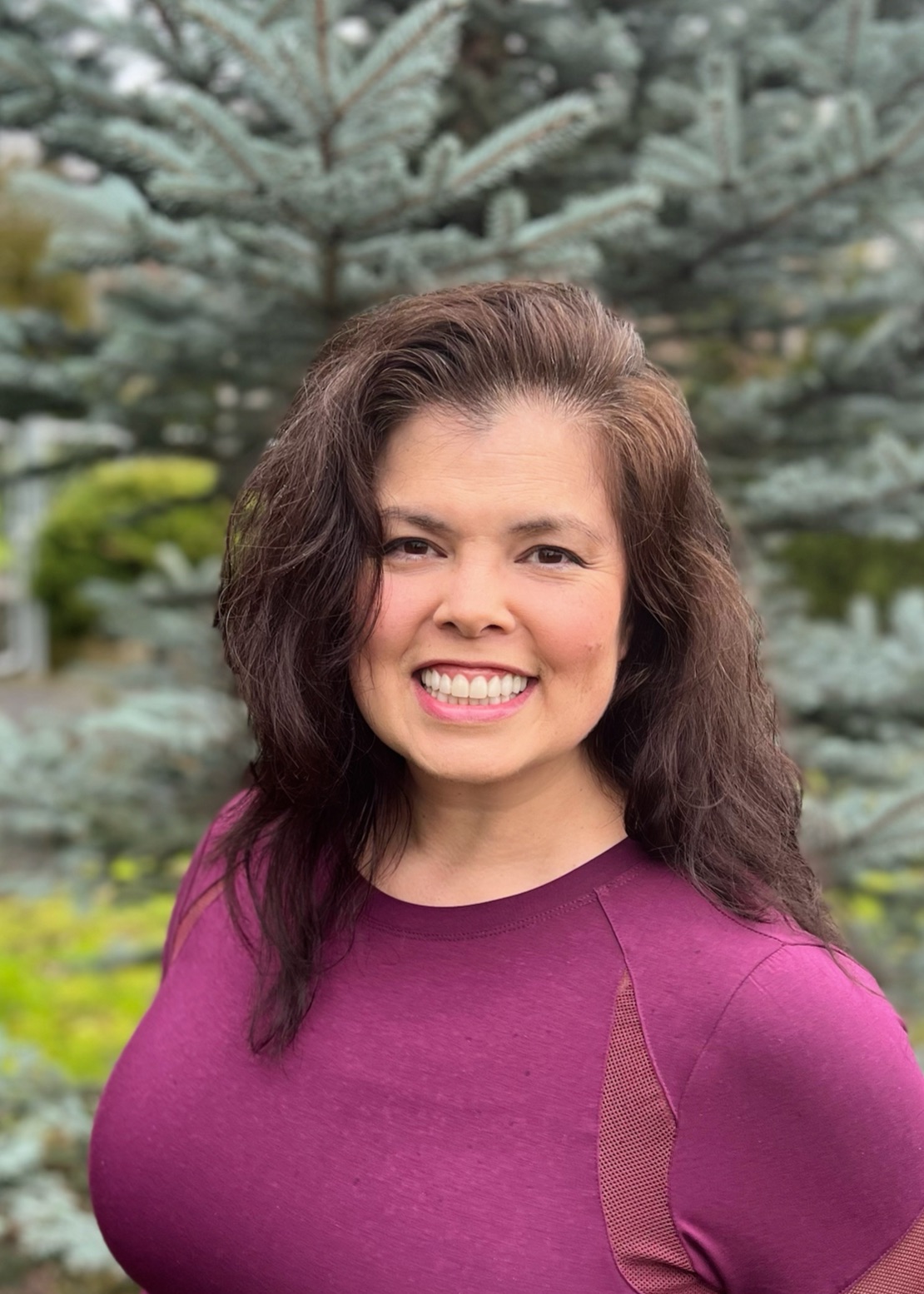 Jeanine Yutani, Scolio-Pilates practitioner and educator in Portland, Oregon, smiling outdoors