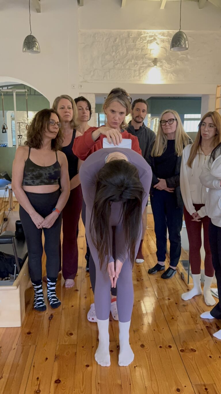 Scoliosis forward bend assessment demonstrated during Scolio-Pilates® practitioner training