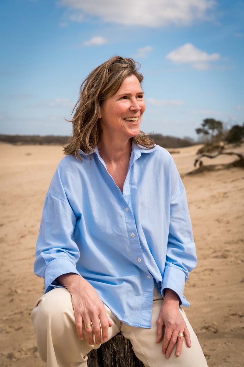 Evelyne Salden, Authorized Scolio-Pilates practitioner in Loon op Zand, Netherlands, smiling outdoors on a beach