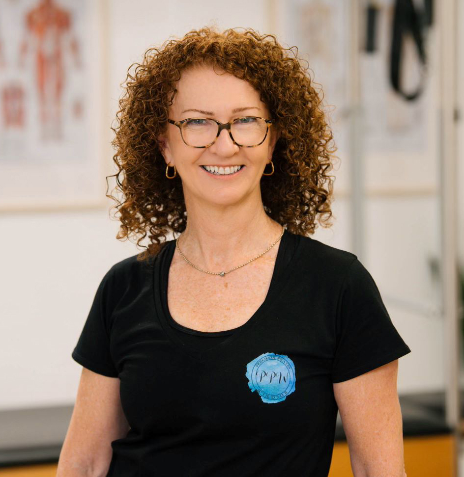 Helen New, Principal Educator for Scolio-Pilates in Windsor and Parkdale, Victoria, Australia, smiling in her studio