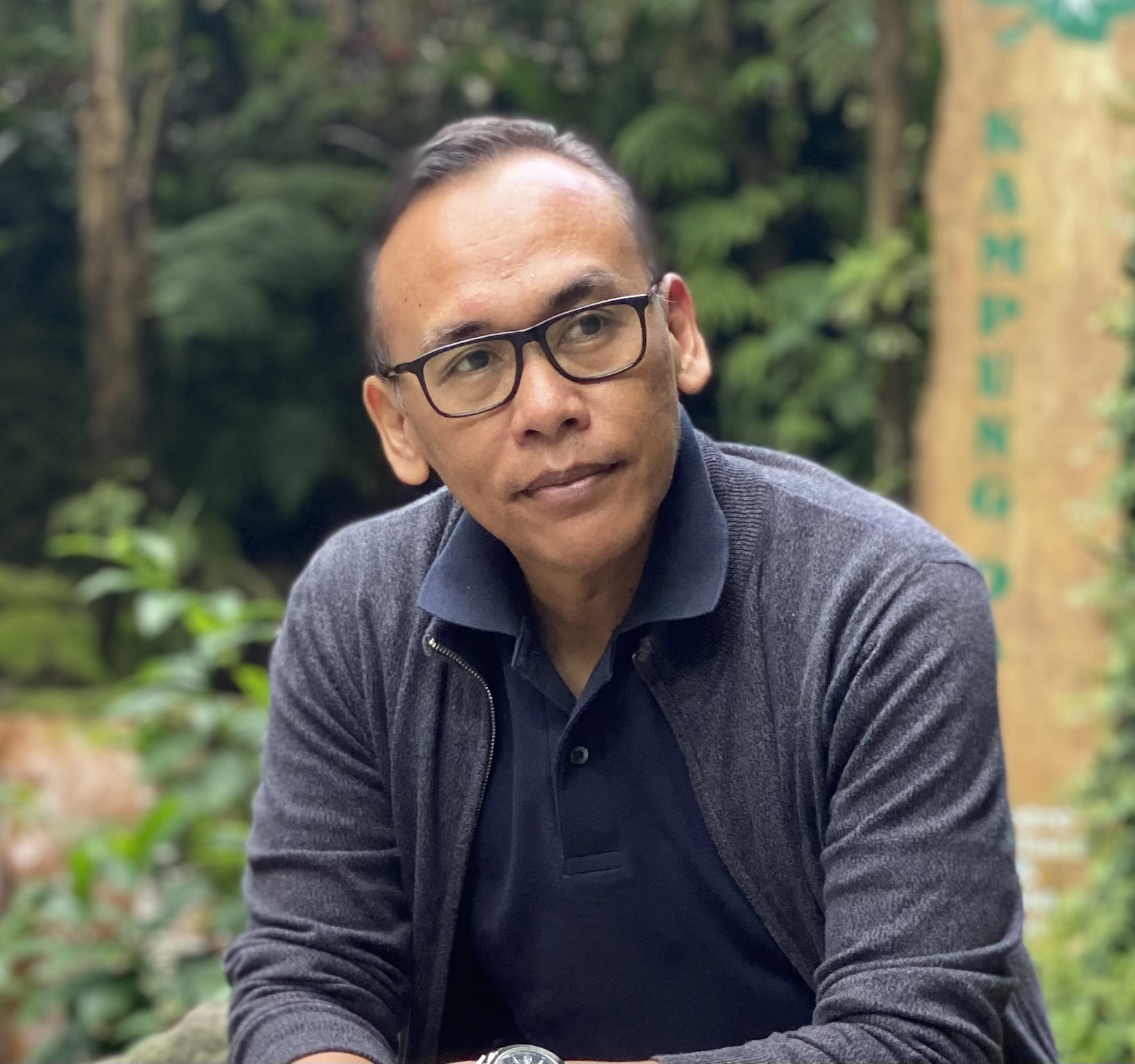 Coach Irwansyah, Authorized Scolio-Pilates practitioner in Medan, Indonesia, seated outdoors