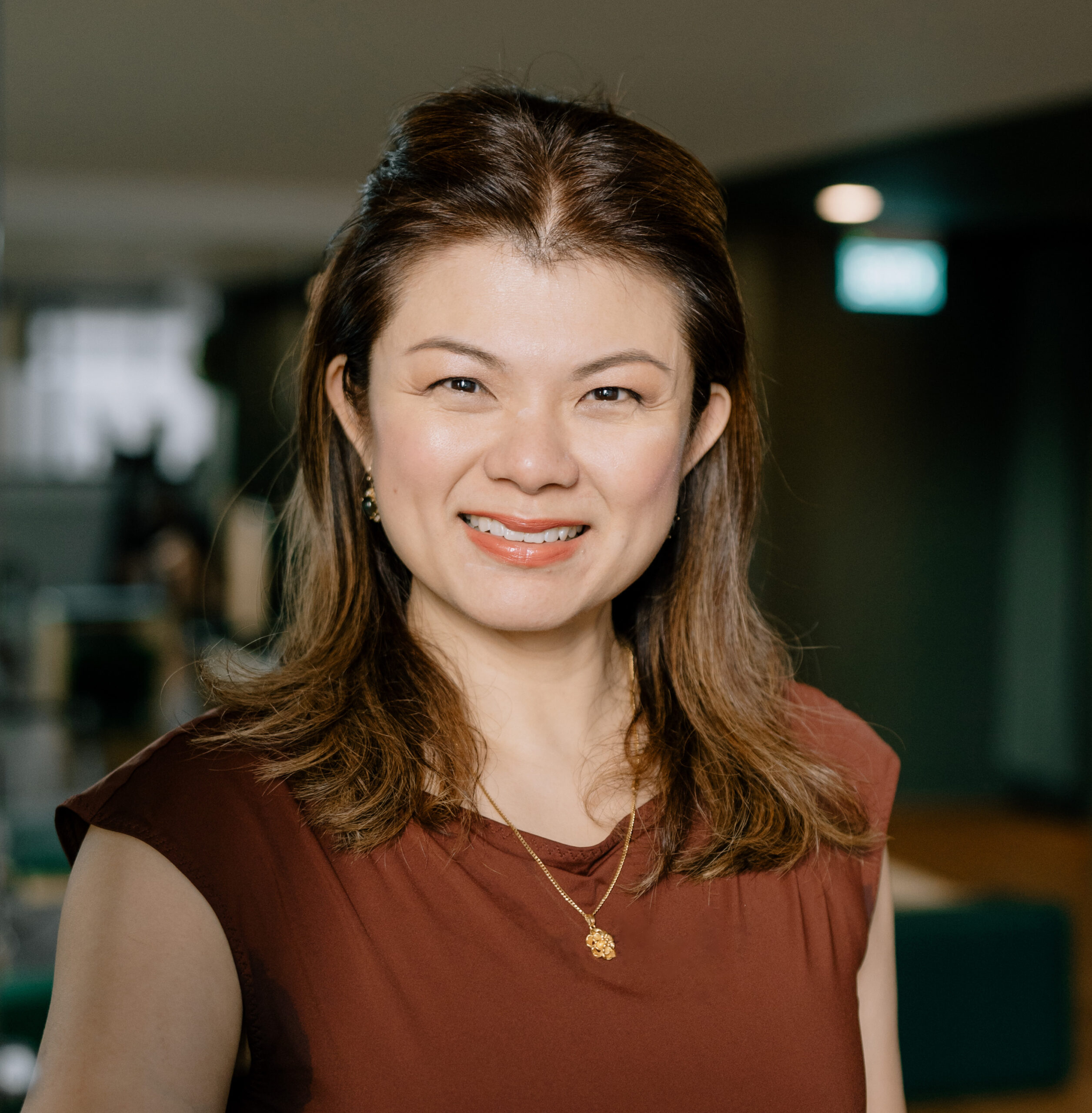 Joanne Chong, Authorized Scolio-Pilates practitioner in Singapore, smiling in a professional portrait