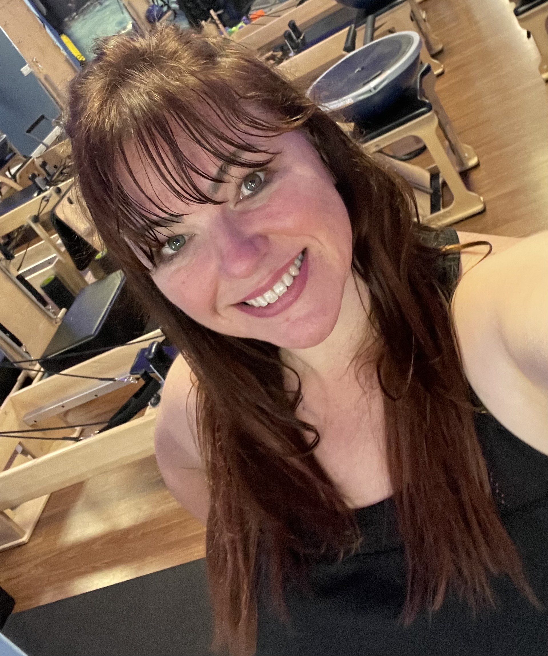 Julianna Crowder, Authorized Scolio-Pilates practitioner in Austin, Texas, smiling in a Pilates studio