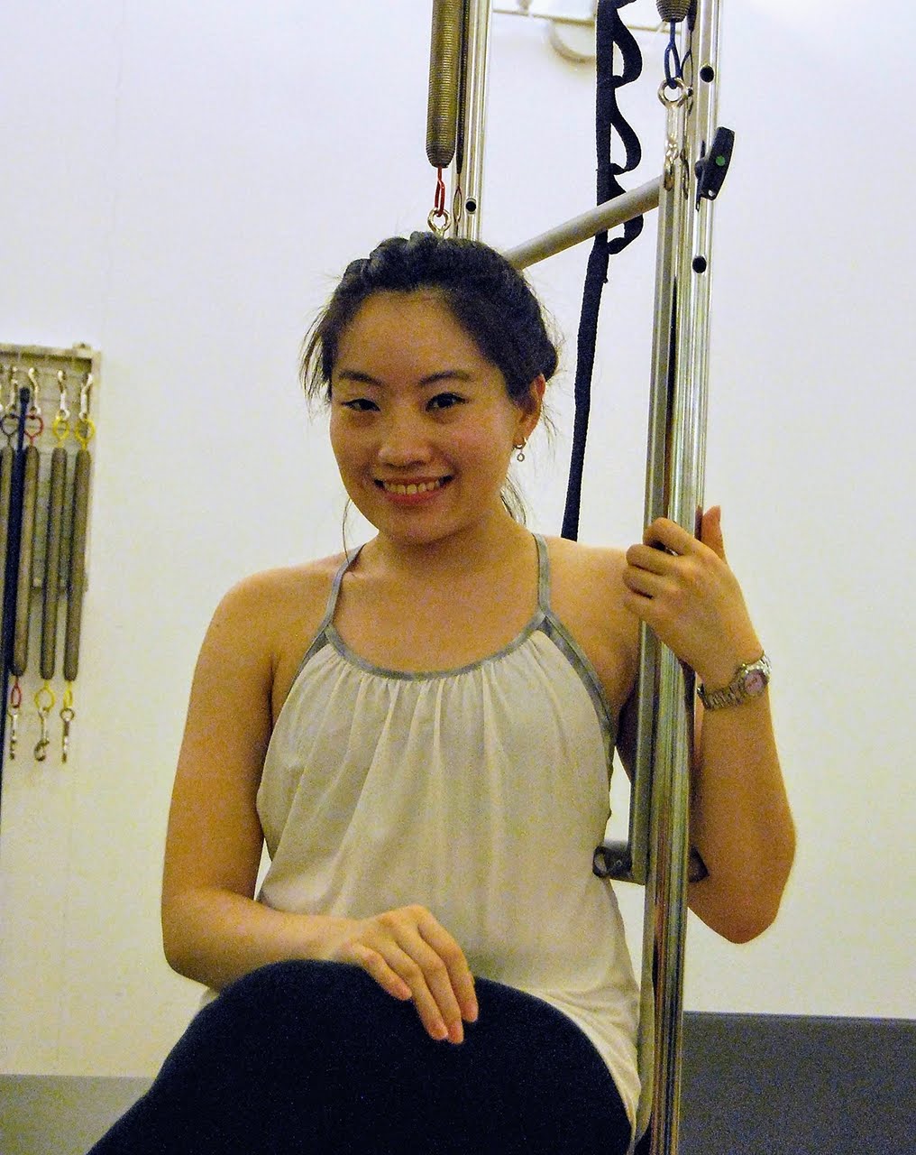Karen Zheng Wen Fang, Scolio-Pilates practitioner in Jakarta, Indonesia, smiling at the reformer