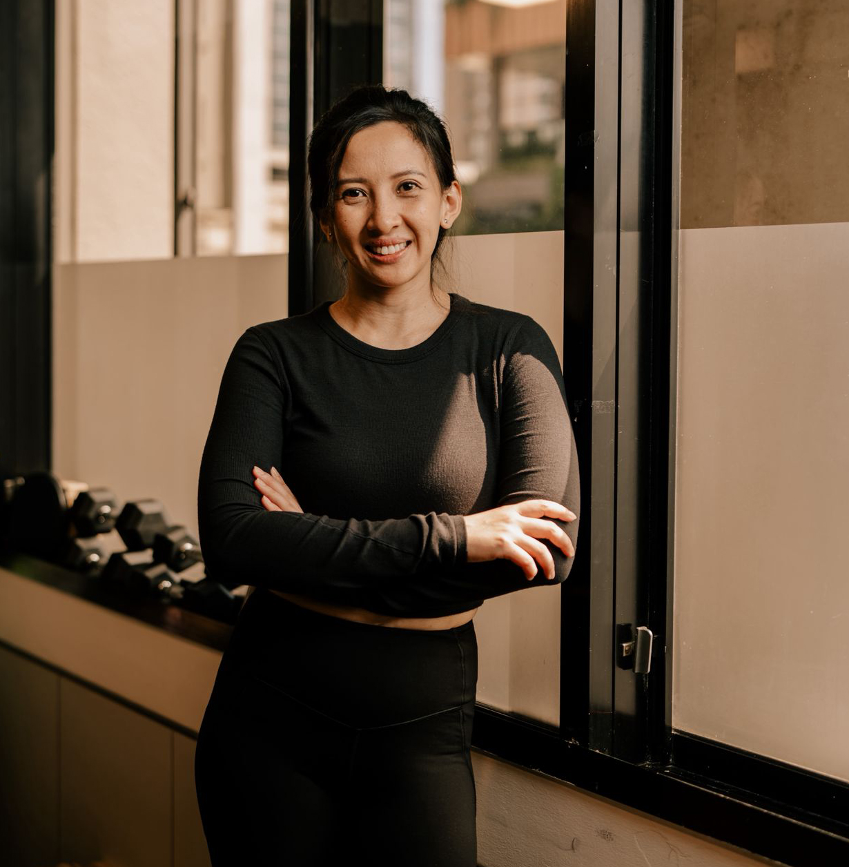 Maegan Teh, Authorized Scolio-Pilates practitioner in Singapore, arms crossed and smiling