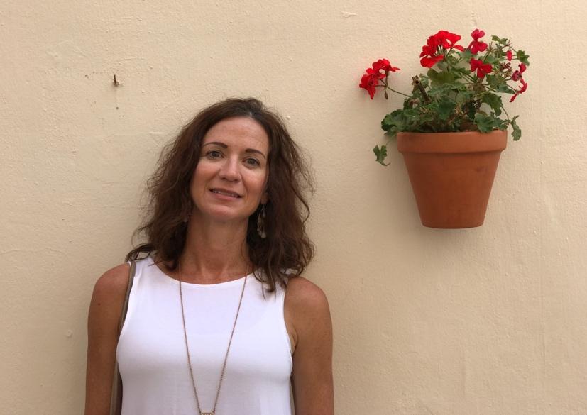 Mary Beth Blend, Authorized Scolio-Pilates practitioner in Richmond, Virginia, smiling outdoors near flowers